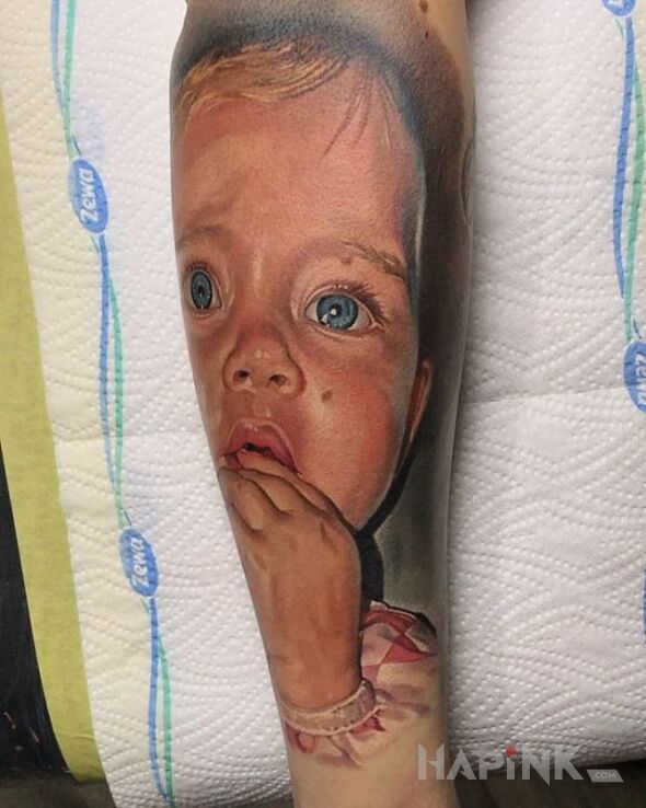 Tattoo Portret dziecka in colorful motif and realistic style on the forearm