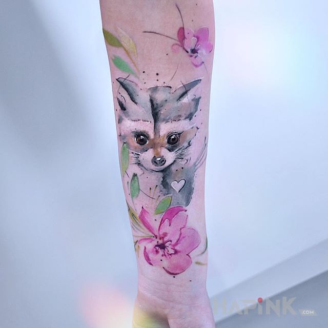 Tattoo Mały borsuk in flowers motif and Watercolor style on the forearm