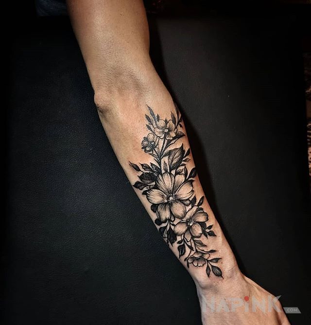 Tattoo Flora in black and gray motif and graphic / illustrative style on the forearm