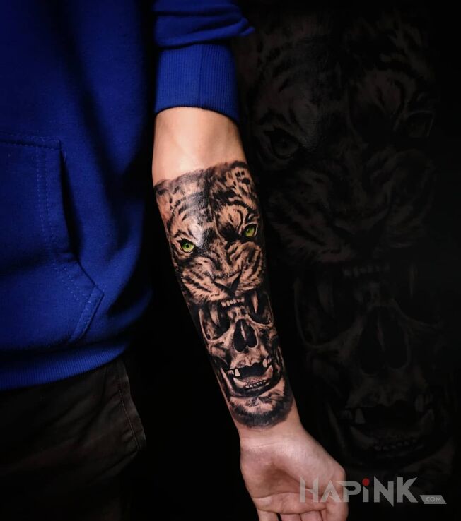 Tattoo Tygrysowa czaszka in skulls motif and realistic style on the forearm