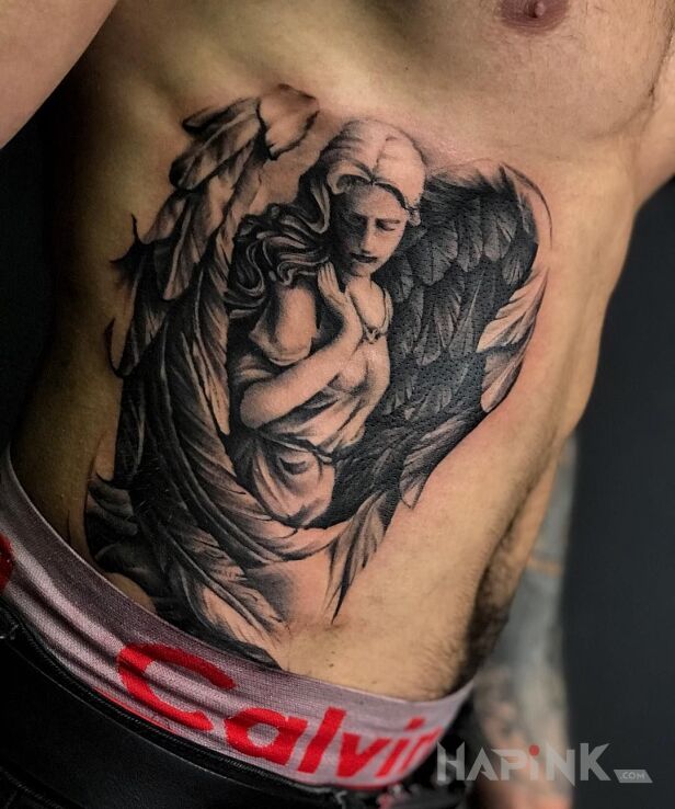 Tattoo Angel in black and gray motif and realistic style on the ribs