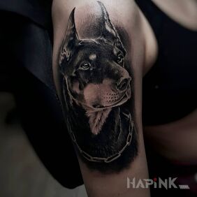 Tattoo Doberman on the upper arm motif: black and gray style: realistic