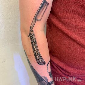 Tattoo A barber's sleeve. One of the tattoos. on the forearm motif: objects style: realistic