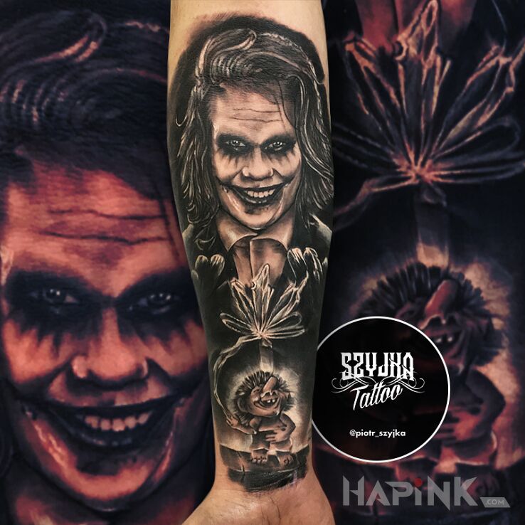 Tattoo Ha ha ha ? in black and gray motif and realistic style on the forearm