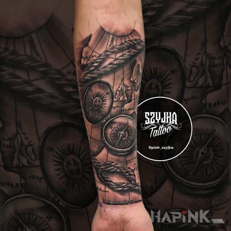 Tattoo Mapy, kompasy ? in black and gray motif and realistic style on the forearm