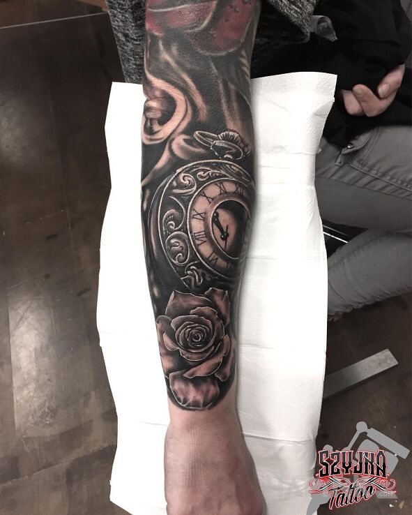 Tattoo Zegar ? in black and gray motif and realistic style on the forearm