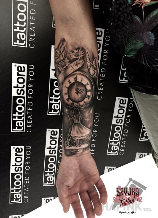 Tattoo Sentymentalny in flowers motif and realistic style on the forearm