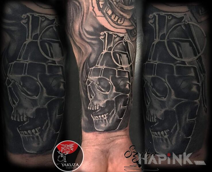 Tattoo Granat in objects motif and realistic style on the forearm