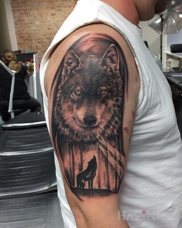 Tattoo Wilk ? in black and gray motif and realistic style on the upper arm