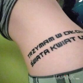 Tattoo I hold the flower of the world hidden in my hands on the ribs motif: lettering