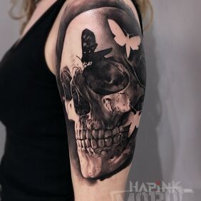 Tattoo Czacha on the upper arm motif: black and gray style: realistic
