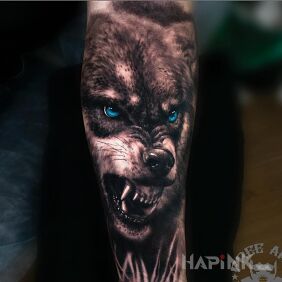 Tattoo The sinister wolf on the forearm motif: black and gray style: realistic