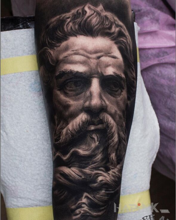 Tattoo Antyczny brodacz in faces motif and realistic style on the forearm