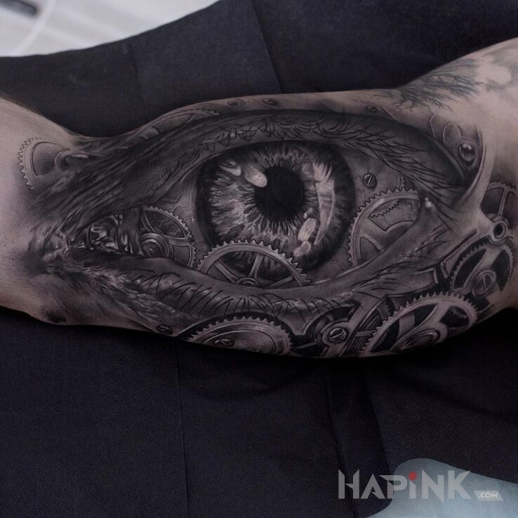 Tattoo Oko w trybach in black and gray motif and realistic style on the upper arm