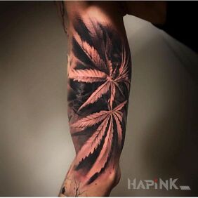 Tattoo Cannabis leaves on the upper arm motif: flowers style: realistic