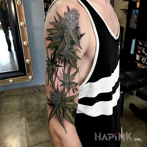 Tattoo Liście i kwiaty marihuany in other motif and realistic style on the upper arm
