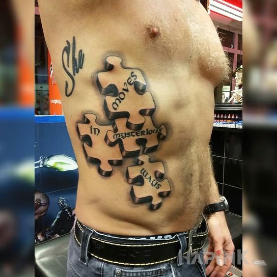Tattoo Piosenka w puzzlach in black and gray motif and graphic / illustrative style on the ribs