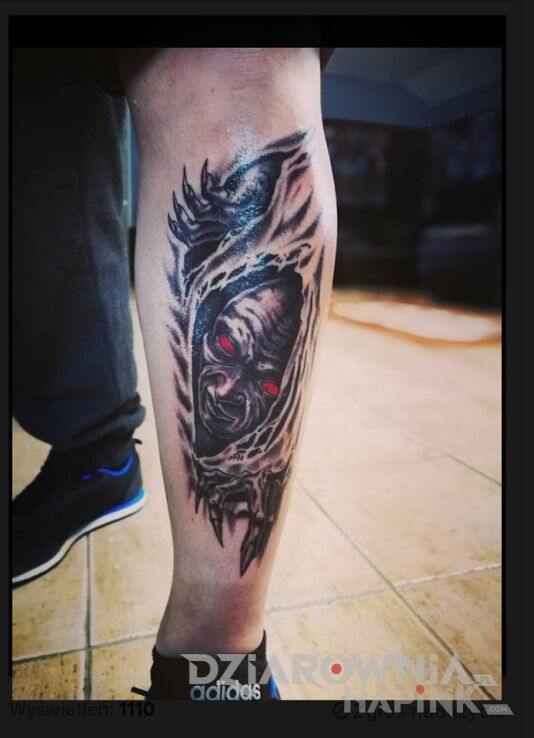 Tattoo Demon in faces motif and graphic / illustrative style on the calf