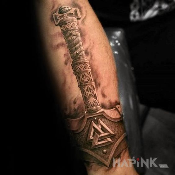 Tattoo Mjolnir in 3D motif and realistic style on the forearm