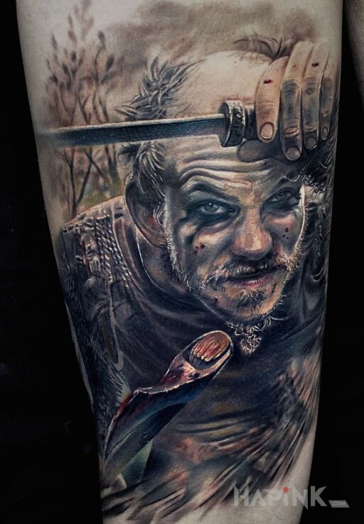 Tattoo Floki z wikingów in colorful motif and realistic style on the forearm