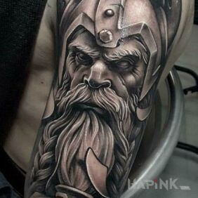 Tattoo Mighty Viking on the upper arm motif: faces style: realistic