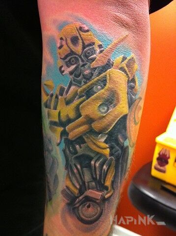 Tattoo Bumblebee in science fiction motif and realistic style On the arm