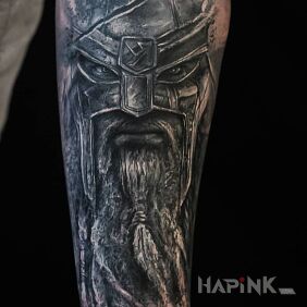 Tattoo Heavy-armed Viking on the forearm motif: faces style: realistic