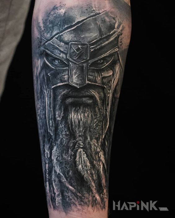 Tattoo Ciężkozbrojny wiking in black and gray motif and realistic style on the forearm