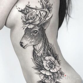 Tattoo Beautiful deer on the ribs motif: flowers style: graphic / illustrative