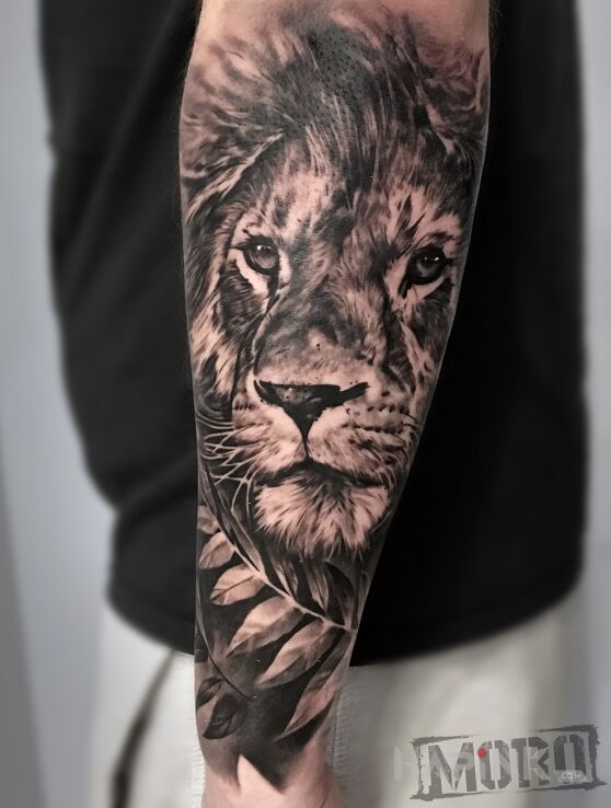 Tattoo Lew in black and gray motif and realistic style on the forearm