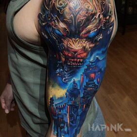 Tattoo Chinese lion on the upper arm motif: colorful style: graphic / illustrative