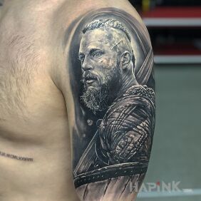 Tattoo Viking ruler Ragnar on the upper arm motif: characters style: realistic