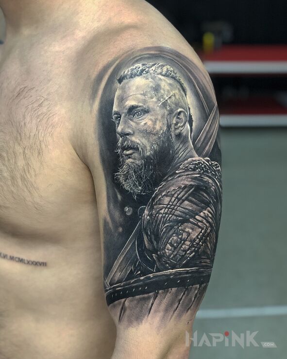 Tattoo Władca wikingów Ragnar in faces motif and realistic style on the upper arm