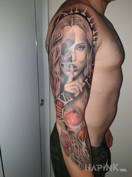 Tattoo CDN in colorful motif and realistic style on the upper arm