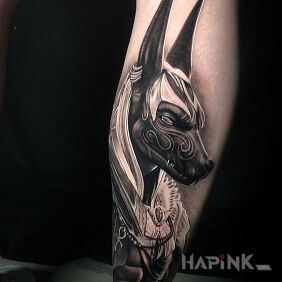 Tattoo Anubis on the calf motif: black and gray style: realistic