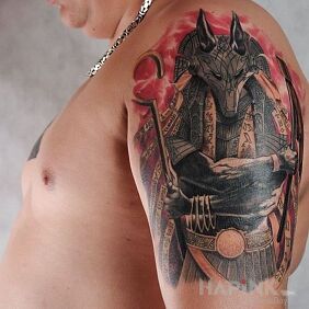 Tattoo Egyptian god on the upper arm motif: characters style: graphic / illustrative