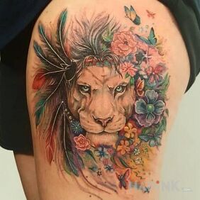 Tattoo Lioness in flowers on the leg motif: flowers style: realistic
