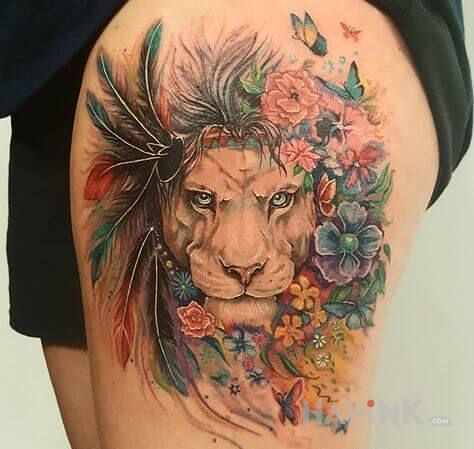 Tattoo Lwica w kwiatach in butterflies motif and realistic style on the leg