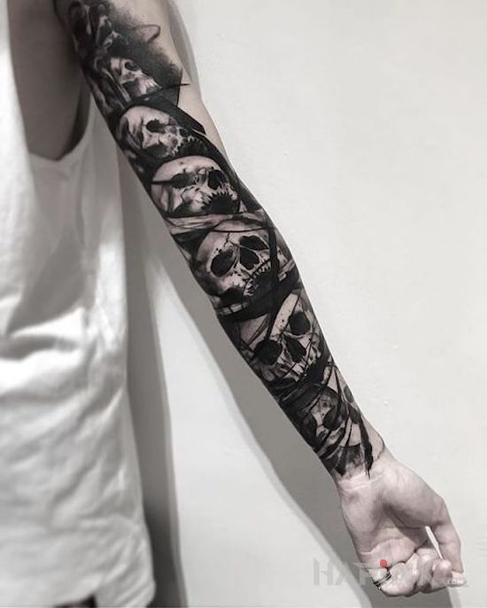 Tattoo Zbiór czaszek in black and gray motif and graphic / illustrative style on the forearm