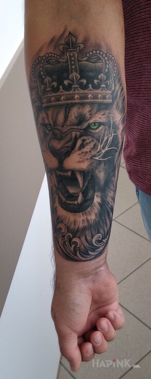 Tattoo Lew Lion in animals motif and realistic style on the forearm