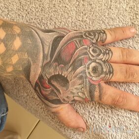 Tattoo Hand on the hand motif: black and gray style: graphic / illustrative