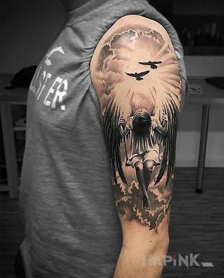 Tattoo Anioł na huśtawce in black and gray motif and realistic style on the upper arm