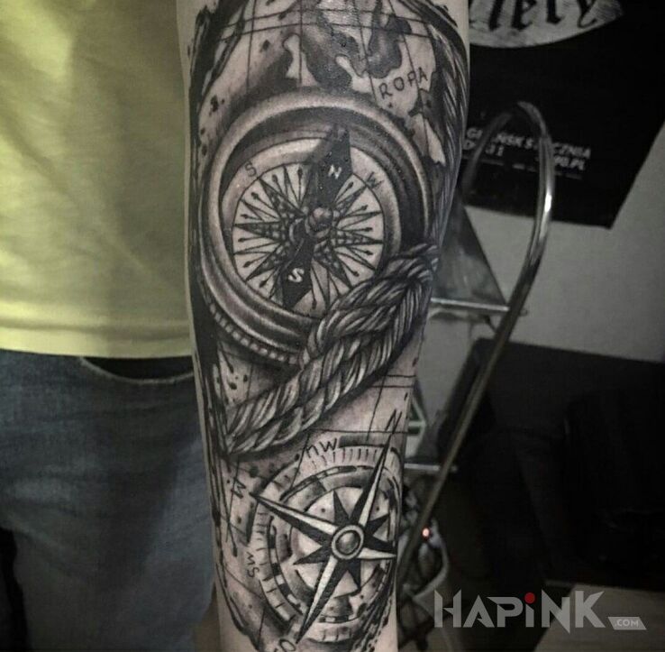 Tattoo Kompas in black and gray motif and realistic style on the forearm