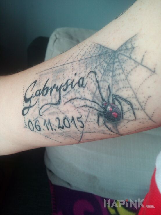 Tattoo Pająk in lettering motif and realistic style on the forearm