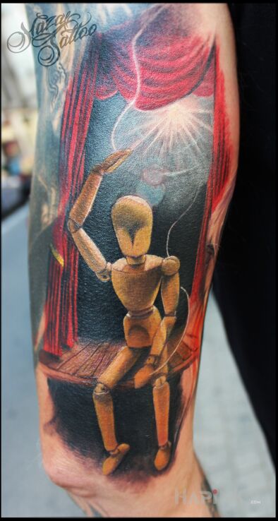 Tattoo Marionette in colorful motif and realistic style on the leg