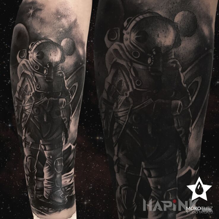 Tattoo Kosmos in black and gray motif and realistic style on the calf