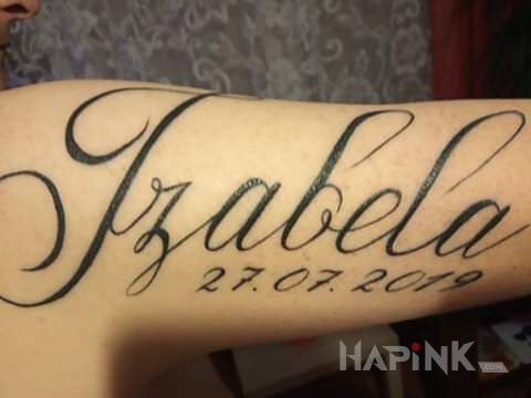 Tattoo Imię drugiej córki in lettering motif on the upper arm
