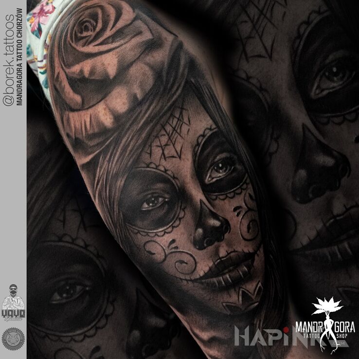 Tattoo Santa muerte in faces motif and realistic style on the upper arm