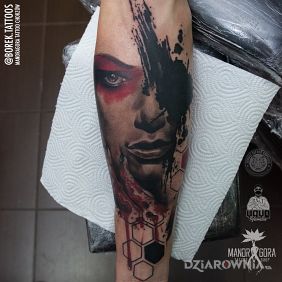 Tatuaż Trashpolka - twarz na przedramieniu motyw: czarno-szare styl: realistyczne