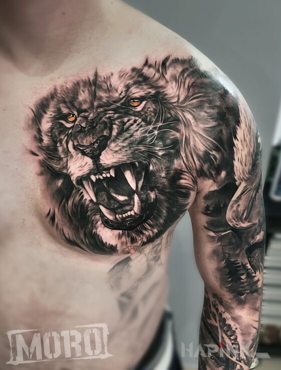 Tattoo Lew in black and gray motif and realistic style on the chest